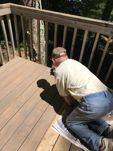 Man staining a deck