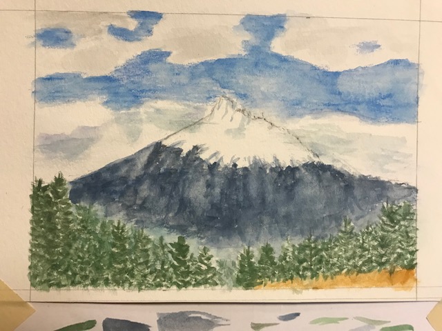 photo of a watercolor painting of a mountain with blue sky and clouds in the background.  On the bottom of the page below the painting there are watercolor brush strokes where the painter was testing colors before using them in the image.