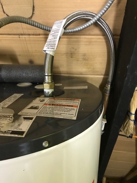 photo of a new pipe connected to a hot water heater