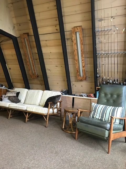 image of a-frame "living area with couch and green chair