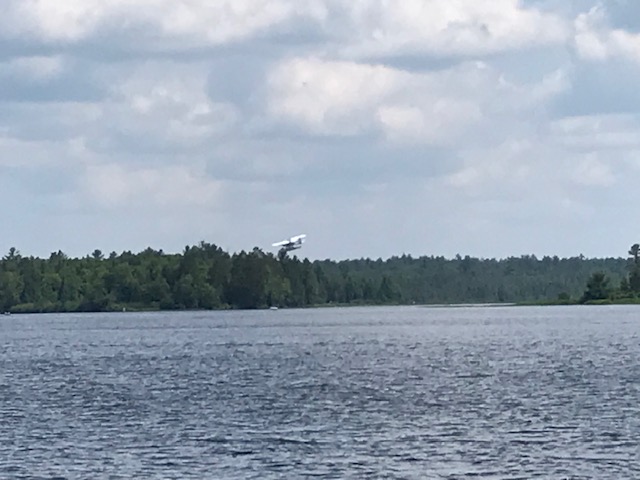 image of a sea plane taking off from the lake.