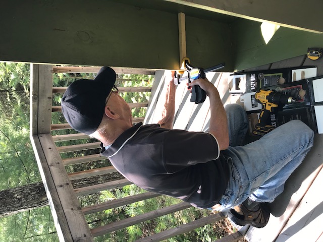 man measuring the inside of the green box