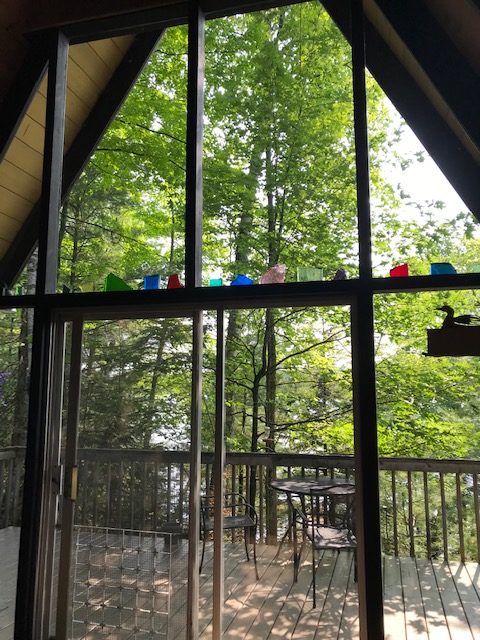 photo of a-frame window and stained glass blocks above the door frame