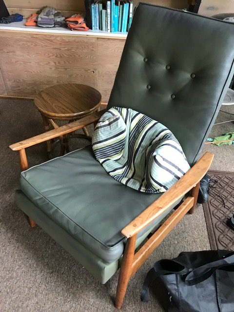 photo of green recliner with wood arm rests