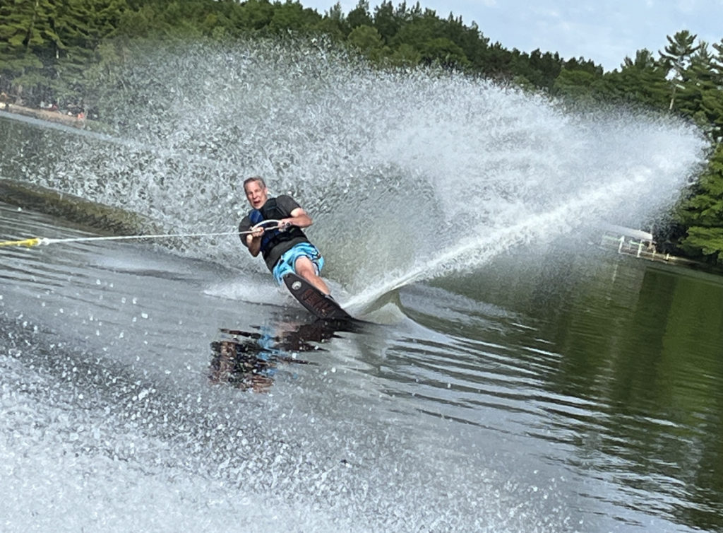 photo of Chris water skiiing with a spray tail fin.