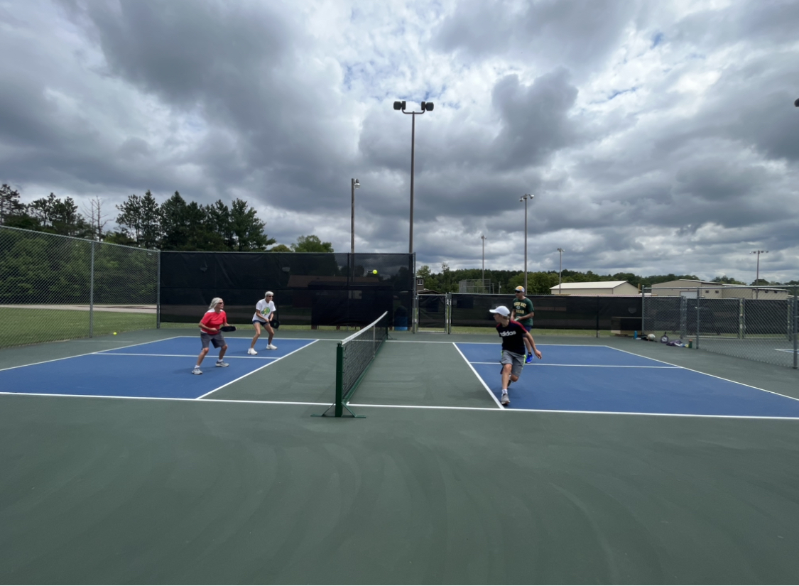 photo of four people playing pickelball