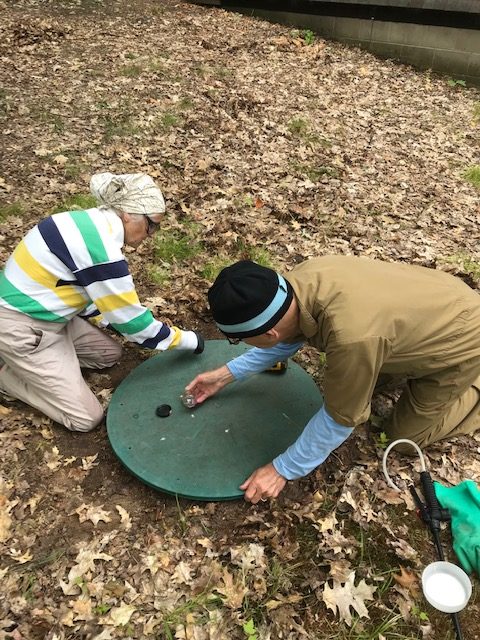 woman and man closing septic tank cover