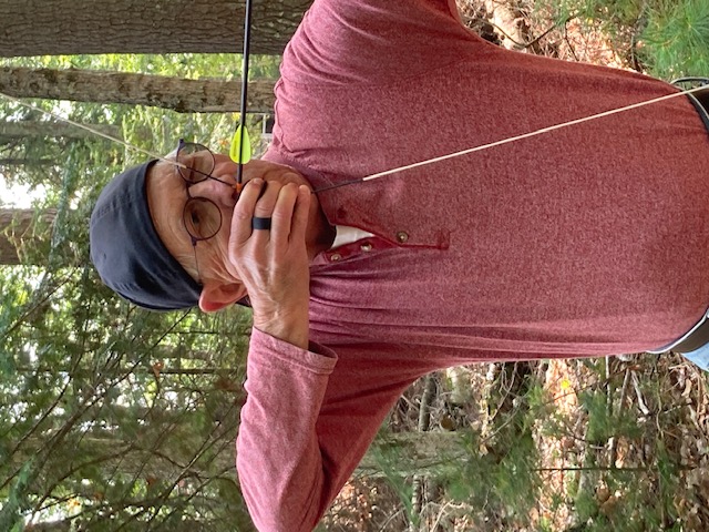 photo of a man shooting a bow and arrow