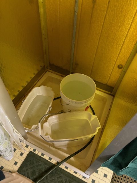 photo of buckets of water in a shower