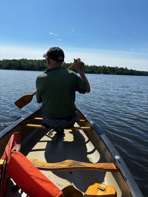 man canoeing on lake