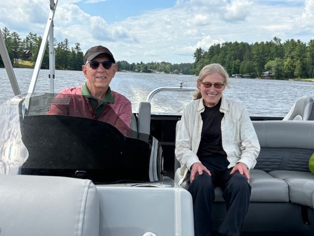 man and woman behind wheel of rented pontoon boat