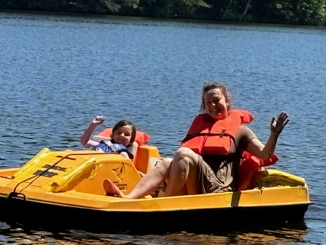 woman with a child in yellow paddleboat