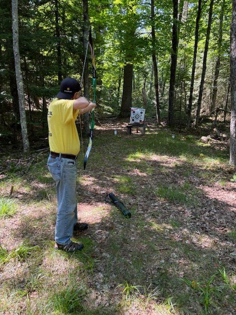 man drawing a bow, about to shoot an arrow