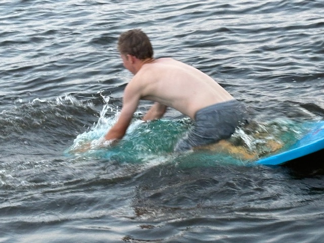 boy on small raft in lake