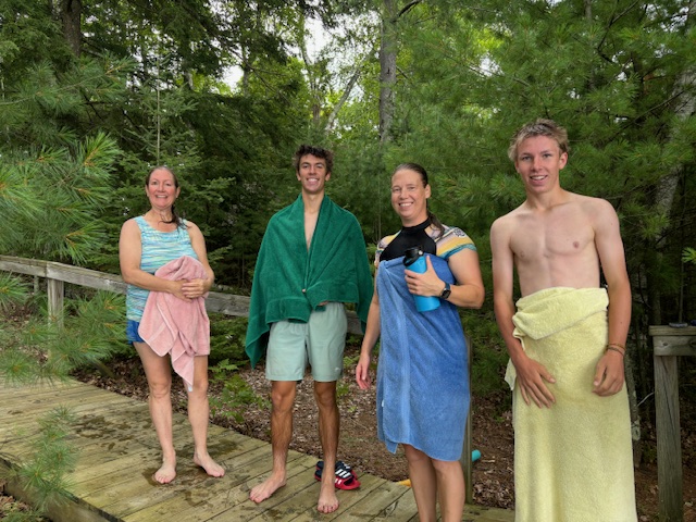 photo of 4 people after they swam across the lake.