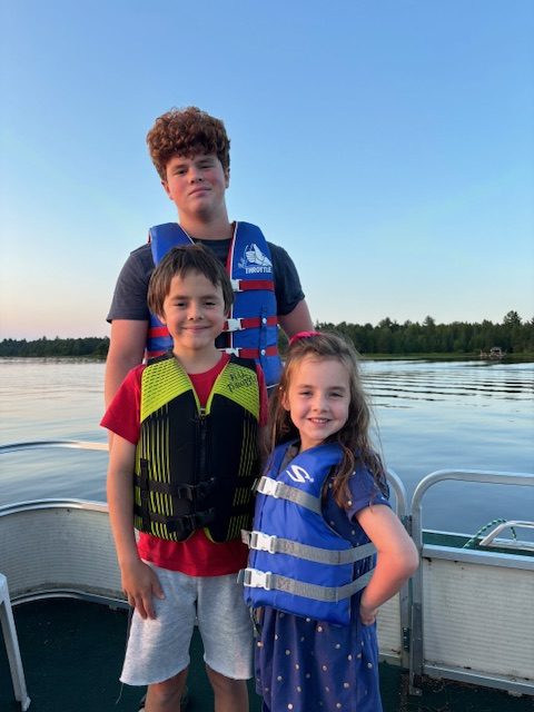 three children on pontoon boat