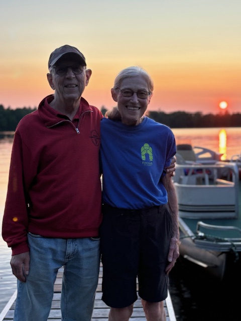 older couple with sunset in photo