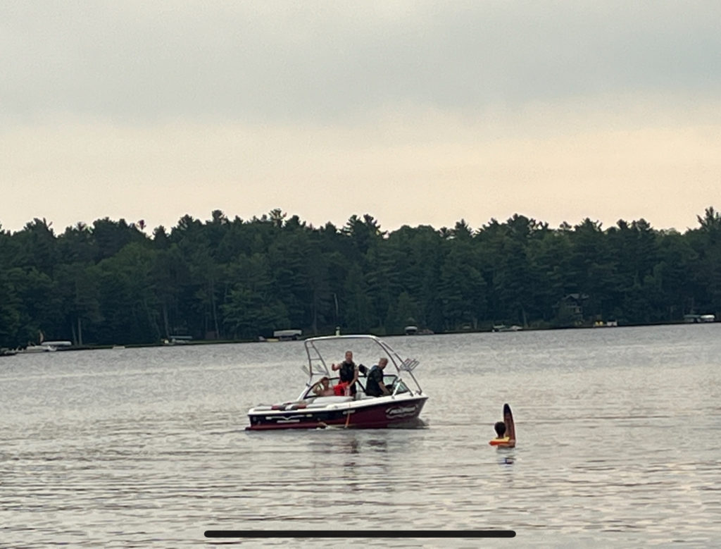 photo of waterski boat with a waterskier waiting to ski